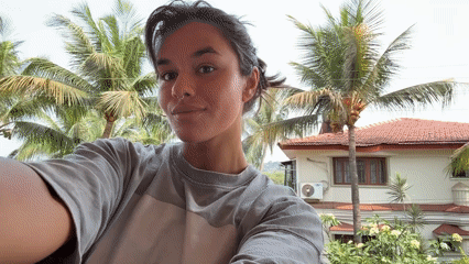 Woman takes selfie on sunny balcony in Marra, India