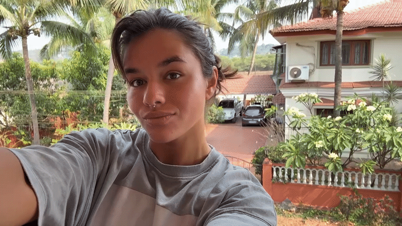 Woman takes selfie on sunny balcony in Marra, India