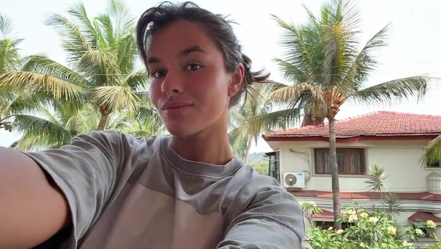 Woman takes selfie on sunny balcony in Marra, India