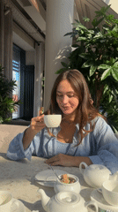 Woman dines at flower-decorated cafe in Surgut, Russia