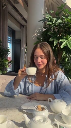 Woman dines at flower-decorated cafe in Surgut, Russia