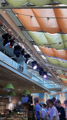 Children's cooking class and stage activities documented at indoor venue
