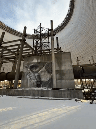 Visitor documents snow-covered Chernobyl cooling towers in Pripyat