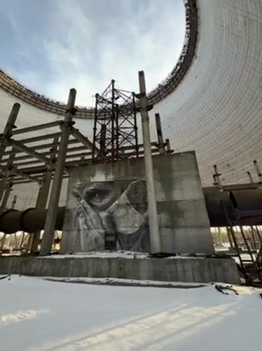 Visitor documents snow-covered Chernobyl cooling towers in Pripyat