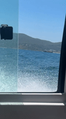Boat passenger films window view in Nha Trang waters