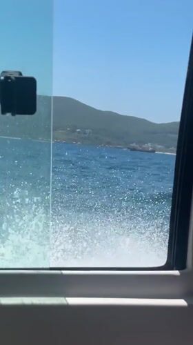 Boat passenger films window view in Nha Trang waters