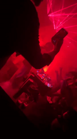 DJ performs at Chennai nightclub with red lasers, dancing crowd