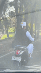 Traditional-dressed rider spotted on scooter in Kuta, Indonesia