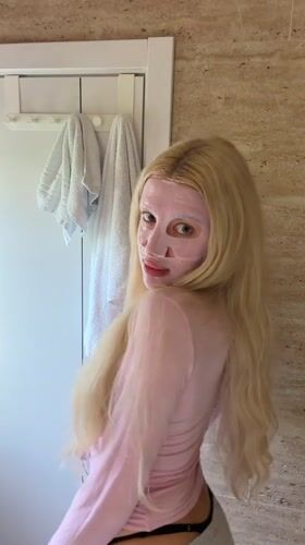 Woman documents facial mask routine in Belgrade bathroom