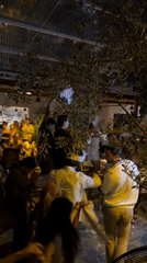 Nighttime celebration with dancing crowds captured at Kuta Selatan venue