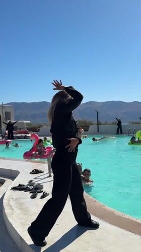 Resort staff run poolside dance and aerobics session in Sicily