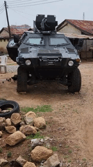Armored Military Vehicle Spotted on Gravel Surface
