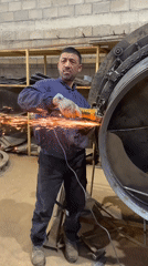 Worker operates angle grinder on metal cylinder in Montenegro
