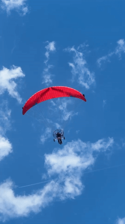Paraglider spotted over calm Nea Vrasna beach on clear day
