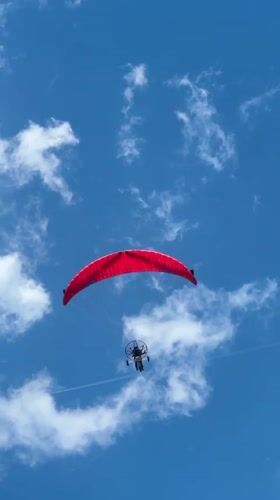 Paraglider spotted over calm Nea Vrasna beach on clear day