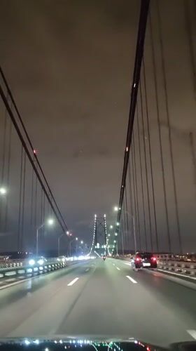 Night drive across suspension bridge captured in Lisbon