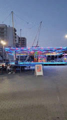 Summer fairground evening in Quarteira — rides, food stalls, lights