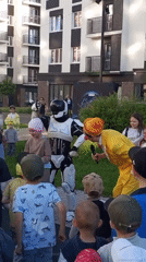 Costumed performers entertain children at Pervomaysky residential courtyard event