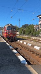 Red train arrives at Tryavna station on sunny morning