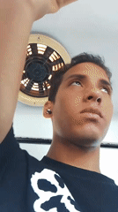 Young man grips overhead bar in casual moment