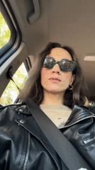 Woman in sunglasses sits in car in Belgrade suburb