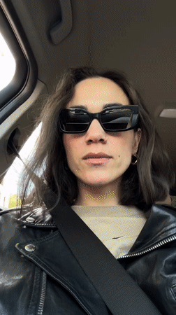 Woman in sunglasses sits in car in Belgrade suburb