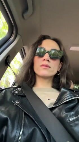 Woman in sunglasses sits in car in Belgrade suburb