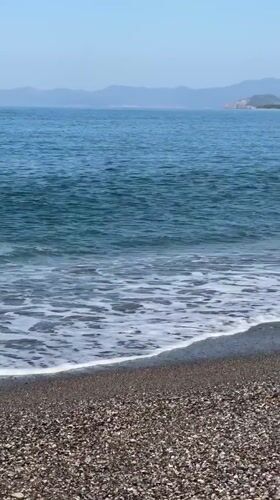 Tourist documents morning beach visit in Fethiye, Turkey