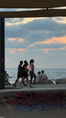 Tel Aviv beach at golden hour, waves and dusk sky