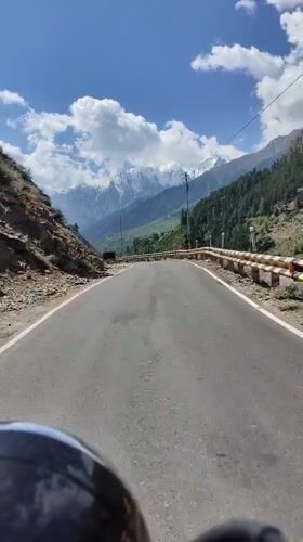 Mountain road through Himachal peaks, prayer flags, and river crossings