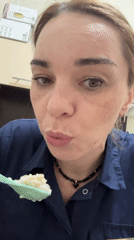 Woman eating with green spoon recorded in Murino, Russia