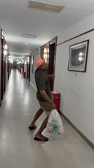 Strolling a hotel hallway in Daxing, bag in hand