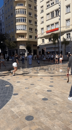 Children play in fountain jets at Alicante square