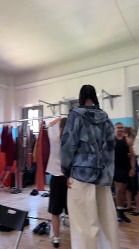 Milan fashion event unfolds across backstage and gymnasium spaces