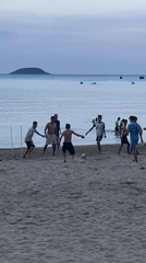 Young men play informal soccer match on Nha Trang beach