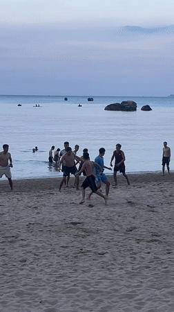 Young men play informal soccer match on Nha Trang beach