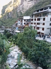 Tourist captures riverside town view in Machupicchu Peru