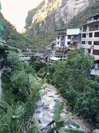 Tourist captures riverside town view in Machupicchu Peru