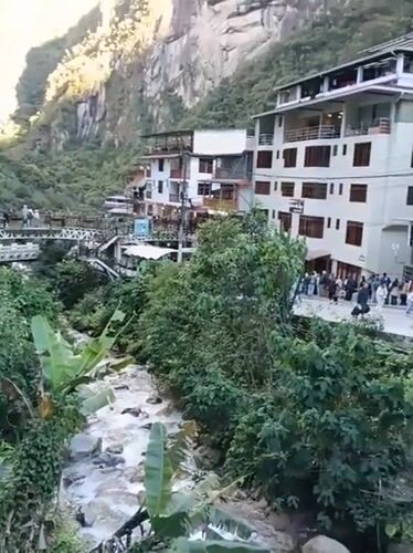 Tourist captures riverside town view in Machupicchu Peru