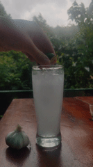 Person prepares lime drink in Messi-branded glass in Da Lat