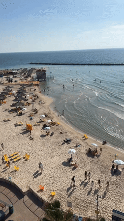 Summer afternoon captured at busy Netanya beach, Israel