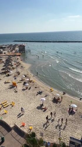 Summer afternoon captured at busy Netanya beach, Israel