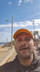 Man documents crane truck activity at Barcelona beach