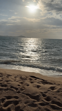 Ko Samui beach morning: fishing, paddleboarding, and a W sculpture