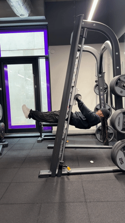 Person exercises at Smith machine in London gym