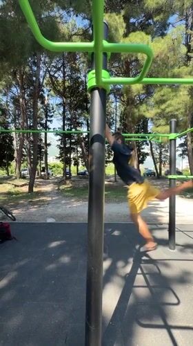 Man performs backflip, calisthenics at outdoor gym in Bar
