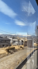Early morning commuter documents snowy mountain views in Nagano