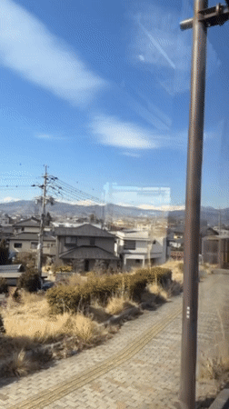 Early morning commuter documents snowy mountain views in Nagano