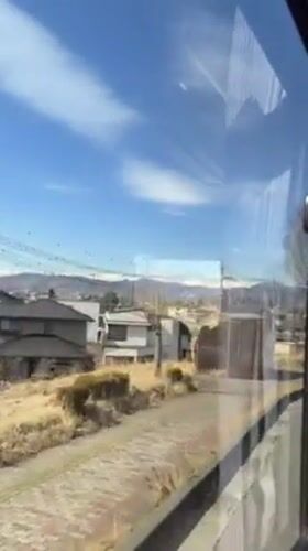 Early morning commuter documents snowy mountain views in Nagano
