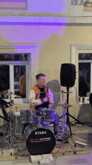 Street drummer performs among shipping container shops in Ufa